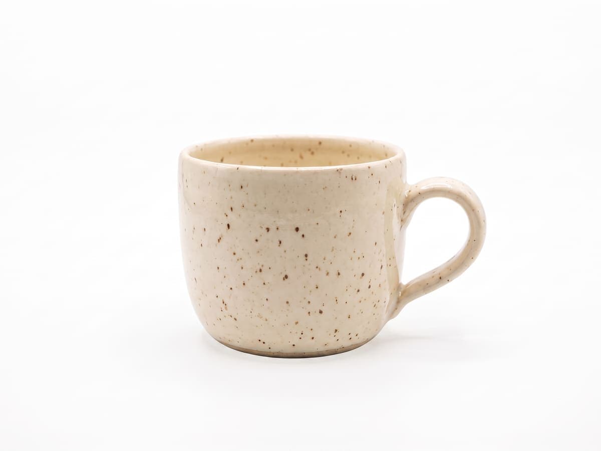 A ceramic mug on white with no shadow, looking flat
