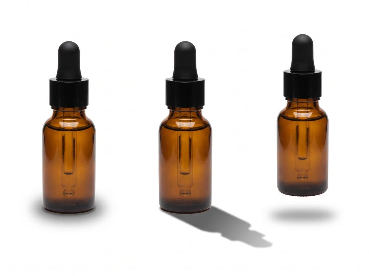 Three amber dropper bottles on white, one with a soft shadow, one with a hard shadow and one floating