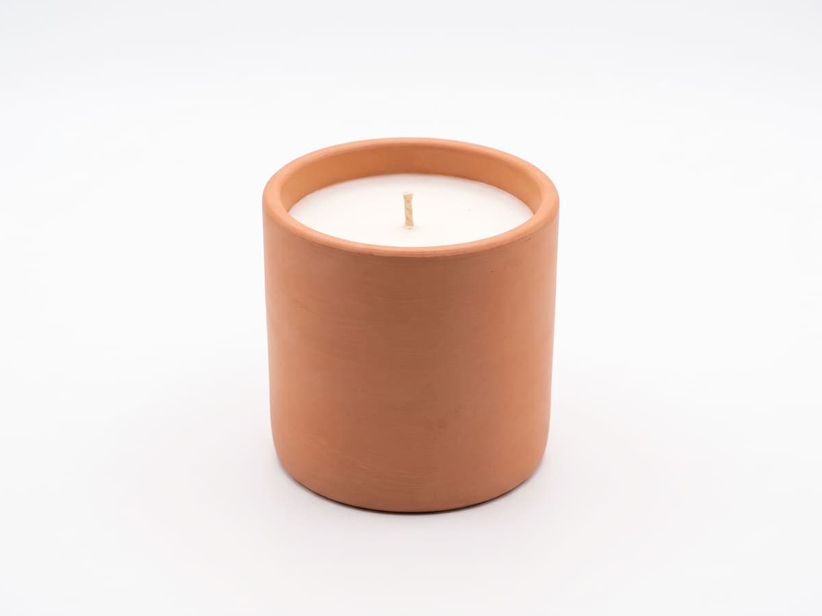 The same terracotta candle on a clean white background