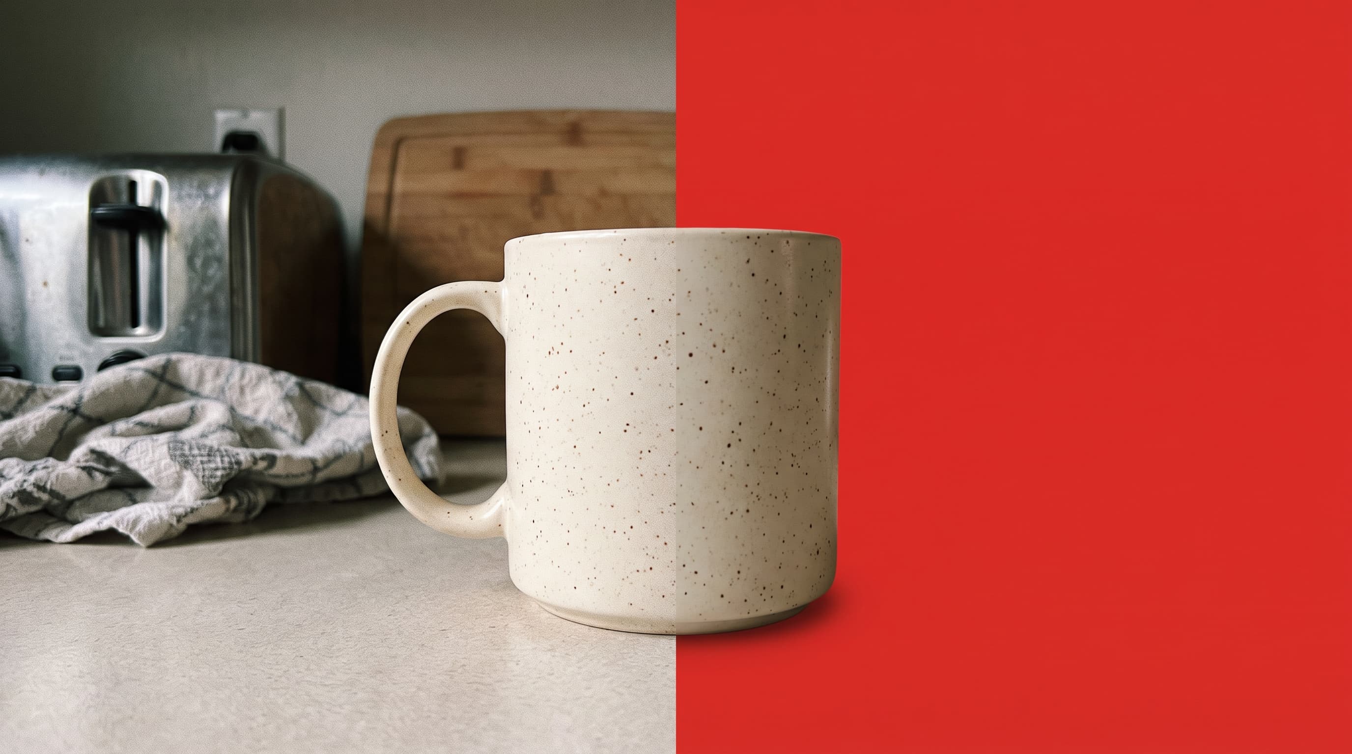 A speckled cream coffee mug on a cluttered kitchen counter on the left, cut out onto a flat red background on the right