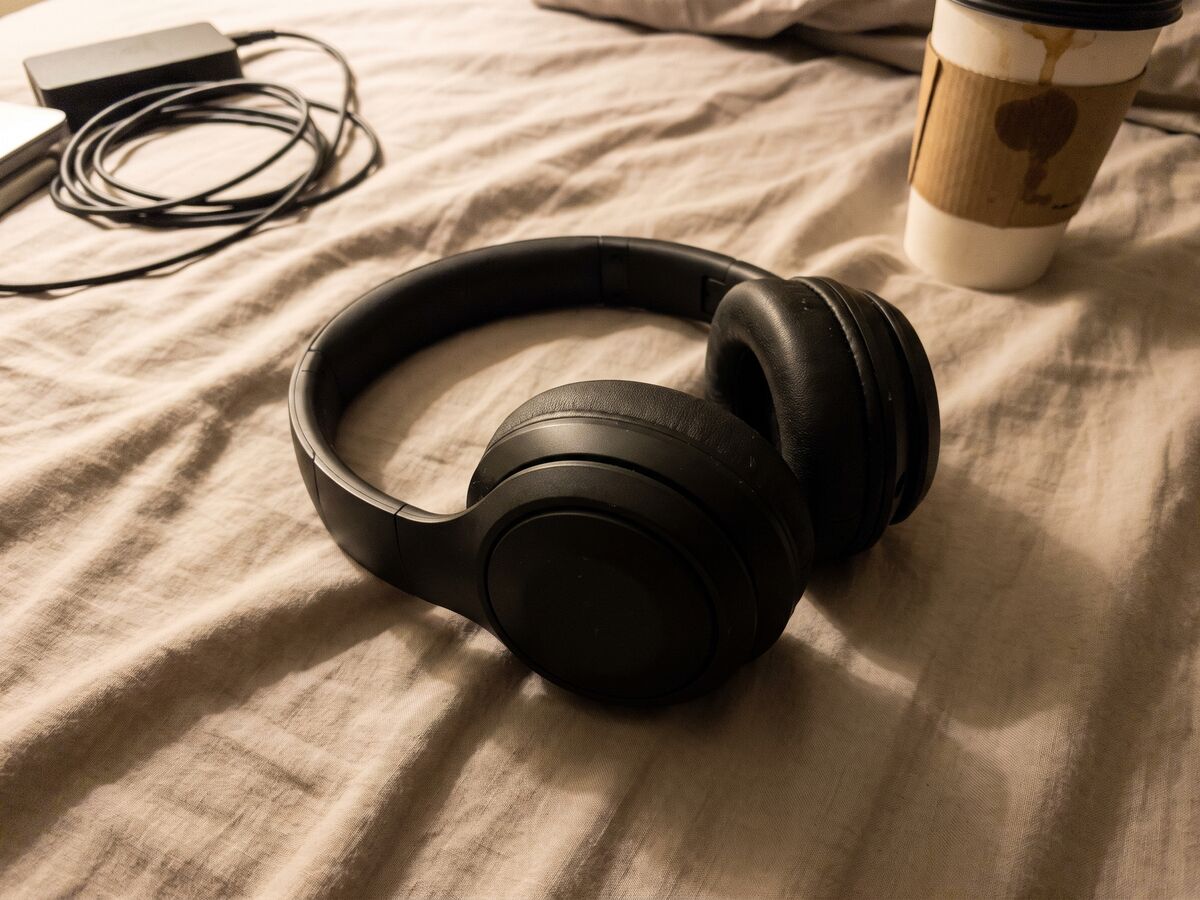 Headphones photographed on a cluttered desk, before editing